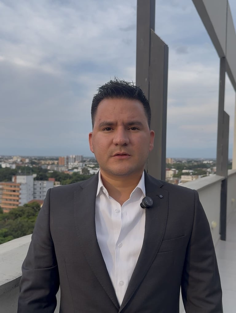 Professional man in dark blazer and white shirt standing on high-rise balcony with city skyline in background